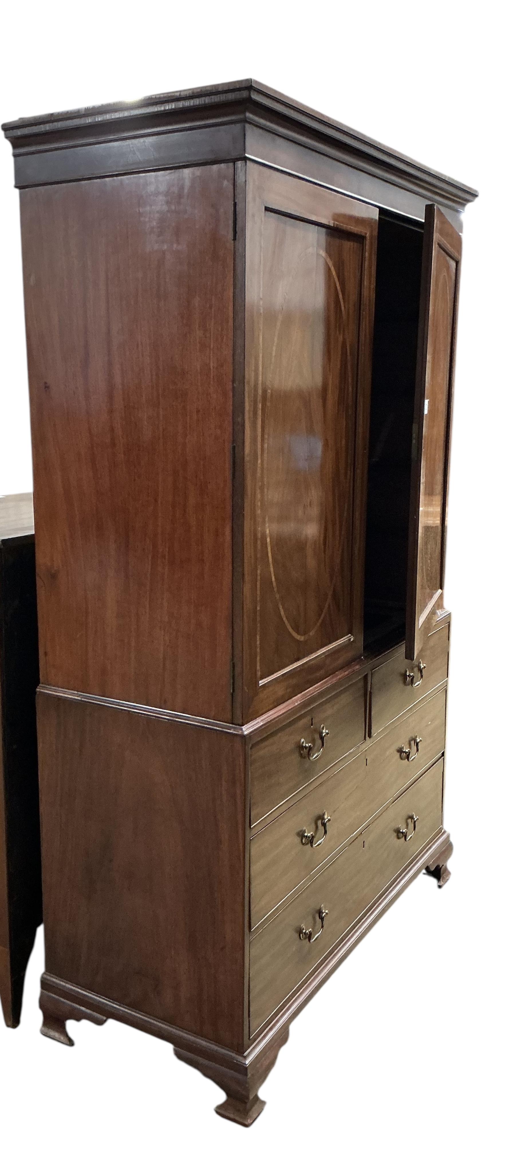 A George III satinwood banded mahogany linen press, converted to a hanging wardrobe, width 126cm, depth 55cm, height 206cm